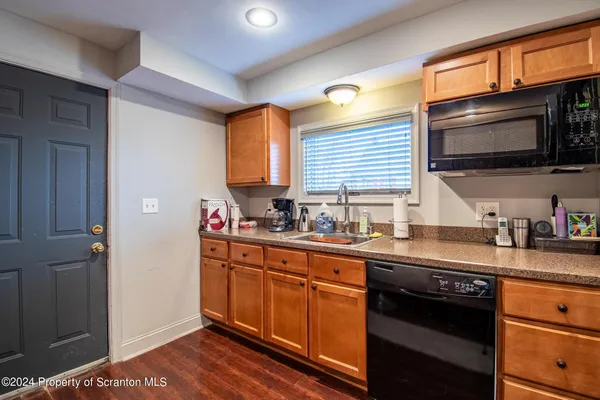 a kitchen with stainless steel appliances a sink stove and cabinets