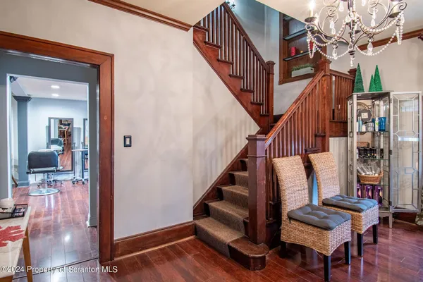 a view of entryway with wooden floor and stairs