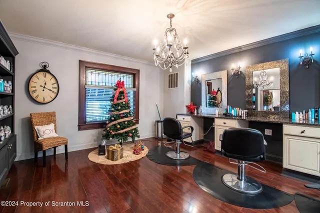 a view of a dining room with furniture a chandelier and wooden floor