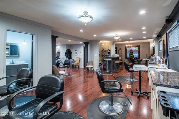 a room with lots of chairs and wooden floor