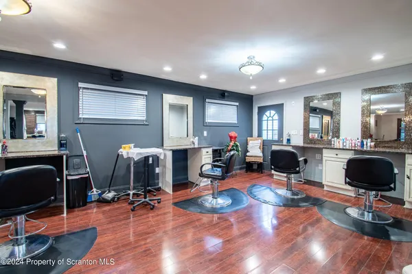 a living room with furniture a flat screen tv and a window
