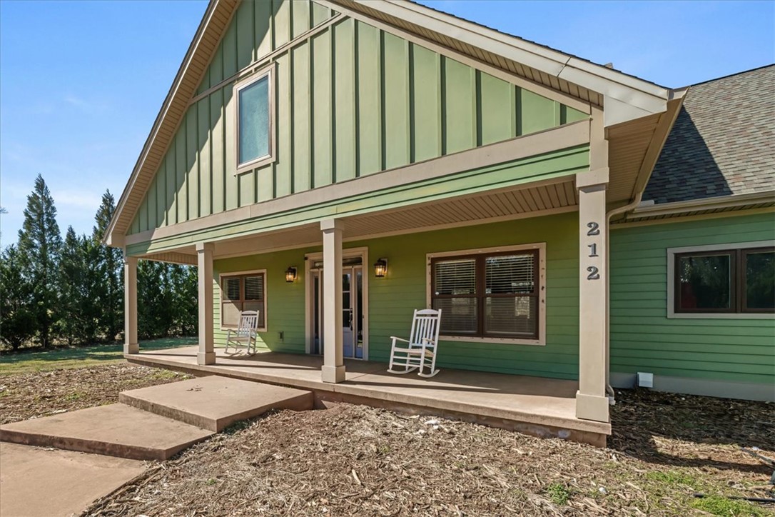 This charming home features a welcoming porch, perfect for relaxing and enjoying the outdoors.