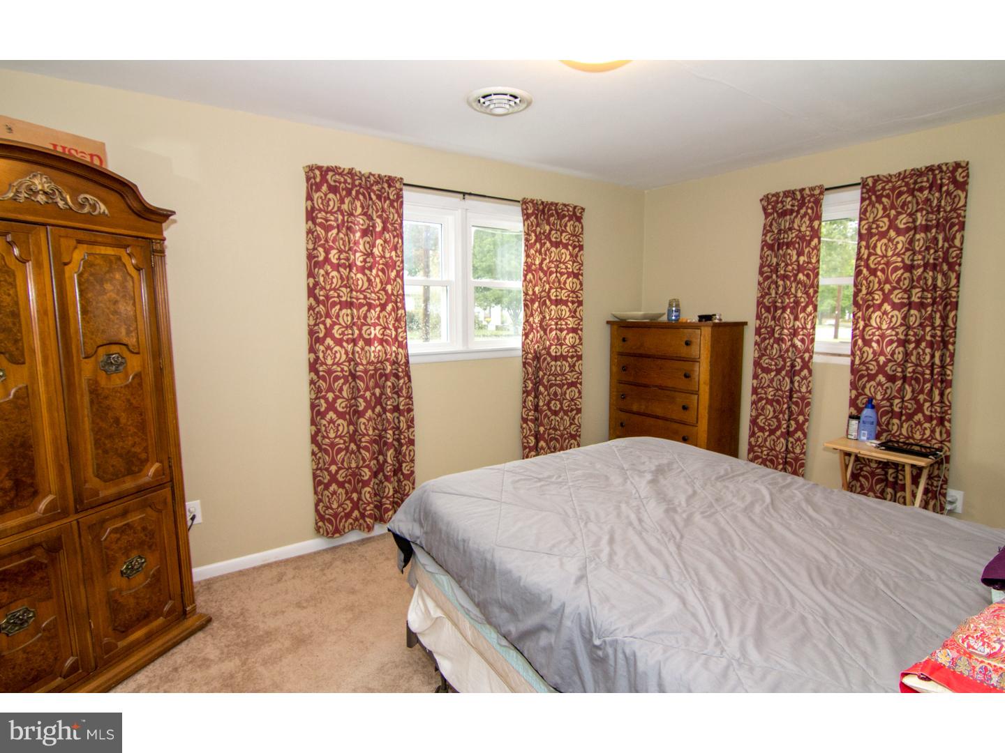 98 Georgia Road Pennsville, NJ 08070 - Photo 16 of 19 a bedroom with a bed and wooden floor