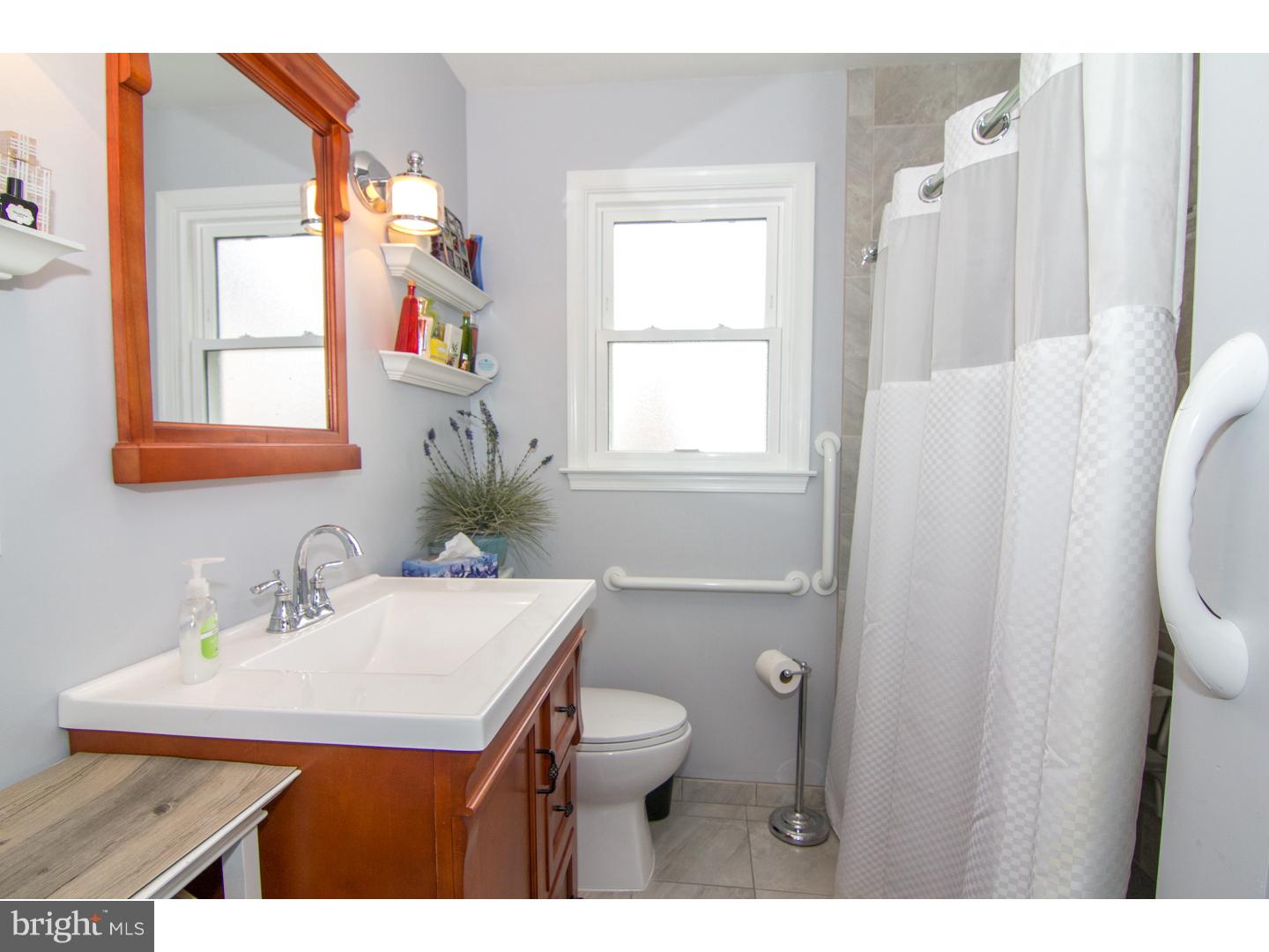 98 Georgia Road Pennsville, NJ 08070 - Photo 18 of 19 a bathroom with a sink toilet and mirror