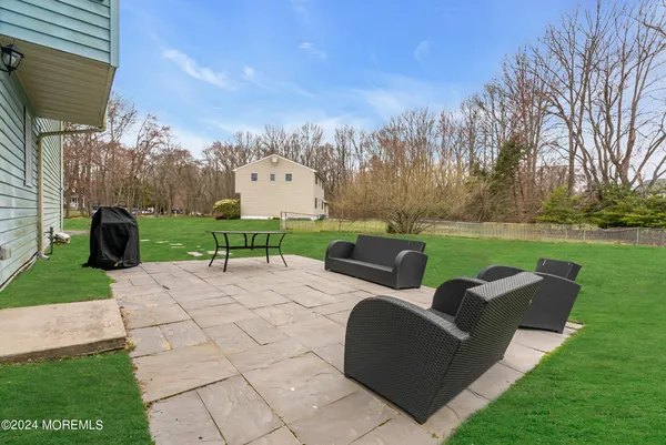 a backyard of a house with table and chairs