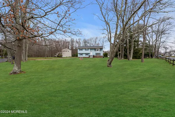 a front view of a house with a garden and yard