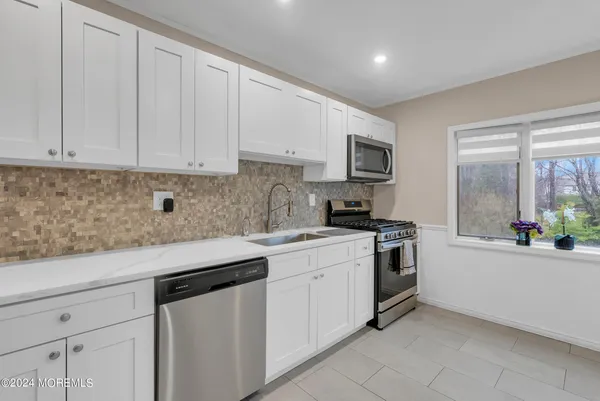 a kitchen with a sink stove and cabinets
