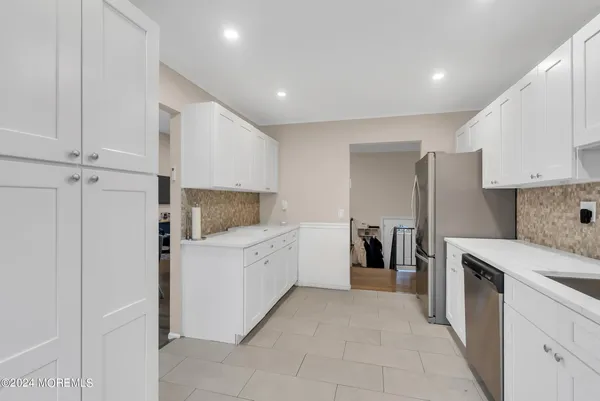 a kitchen with a refrigerator and a stove