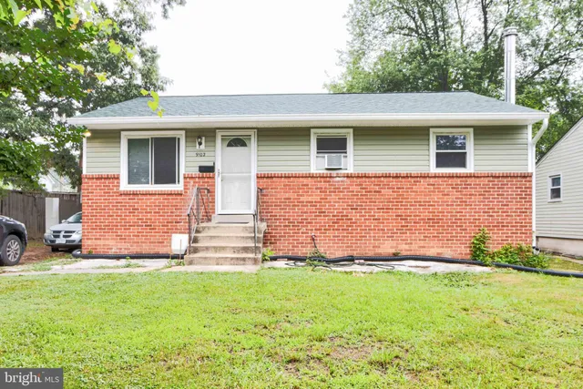 a front view of house with yard and outdoor seating