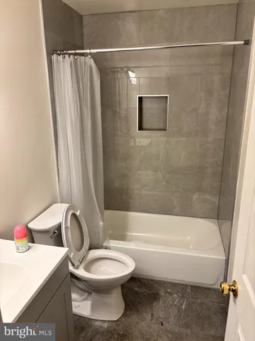 a bathroom with a sink a toilet and a bathtub