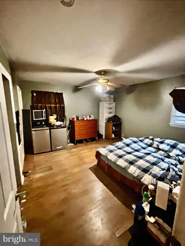 a bedroom with furniture and a flat screen tv