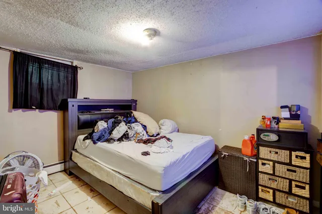 a bed sitting in a bedroom next to a window