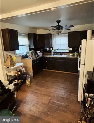 a kitchen with a sink appliances and cabinets