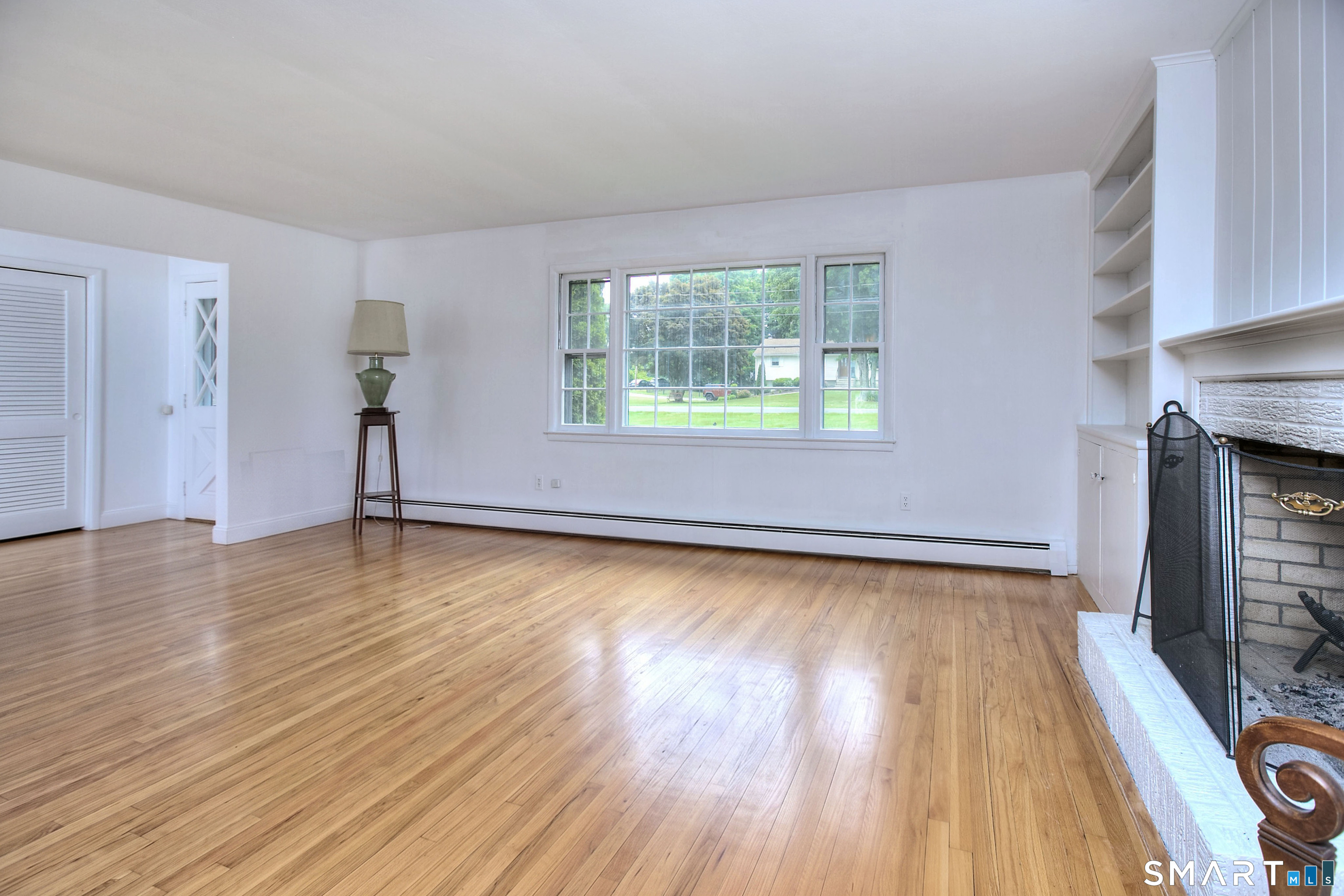 324 Ridge Road Orange, CT 06477 - Photo 5 of 38 an empty room with wooden floor and windows