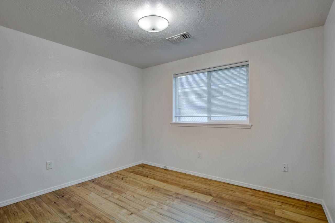 417 Crystal Drive Eagle Point, OR 97524 - Photo 21 of 35 an empty room with wooden floor and windows
