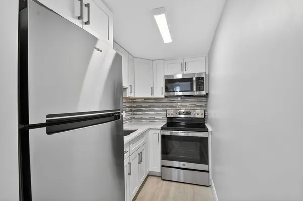 a kitchen with a refrigerator stove and microwave