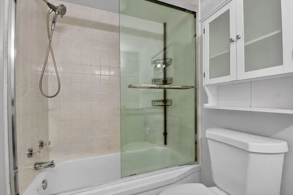 a bathroom with a shower and toilet