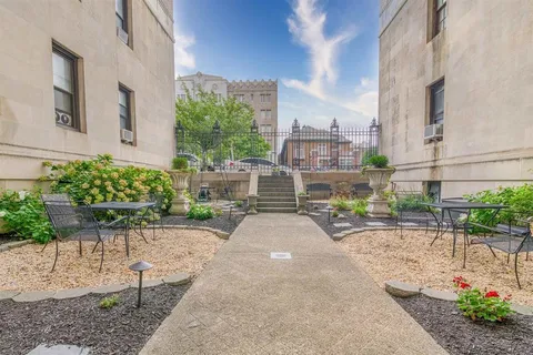 a view of a patio with table and chairs and potted plants