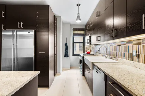 a kitchen with stainless steel appliances granite countertop a refrigerator and a sink
