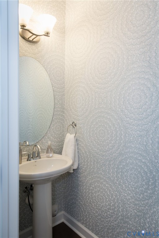 8102 Side Spring Terrace Henrico, VA 23294 - Photo 11 of 20 a bathroom with a sink a mirror and a toilet