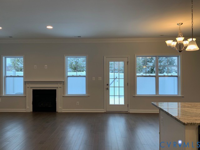 8102 Side Spring Terrace Henrico, VA 23294 - Photo 6 of 20 an empty room with wooden floor fireplace and windows