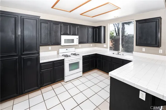 a kitchen with stainless steel appliances a sink stove and cabinets