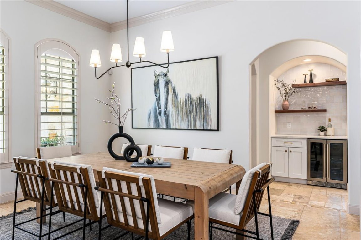 213 Black Wolf Run Austin, TX 78738 - Photo 11 of 39 a view of a dining room with furniture and a chandelier