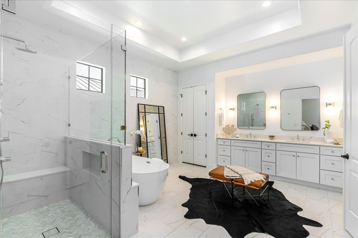 213 Black Wolf Run Austin, TX 78738 - Photo 14 of 39 a spacious bathroom with a bathtub shower sink mirror and toilet