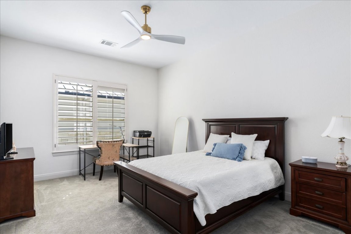 213 Black Wolf Run Austin, TX 78738 - Photo 15 of 39 a bedroom with a bed and a table chair