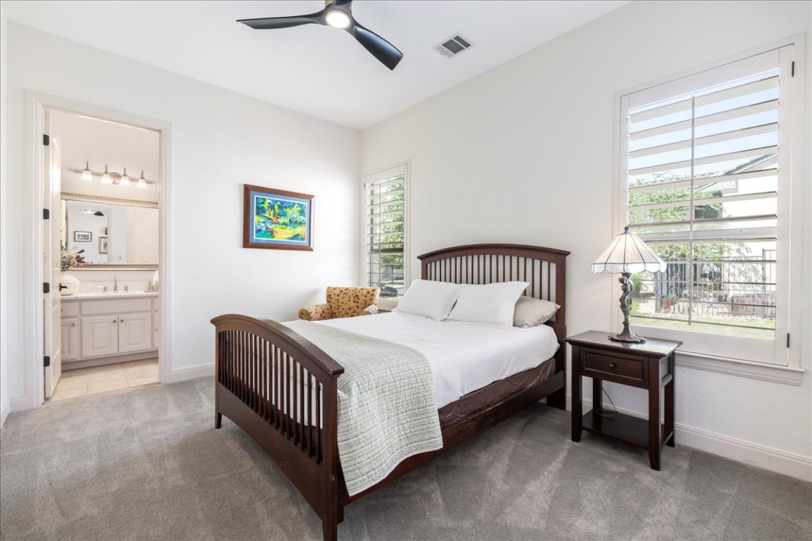 213 Black Wolf Run Austin, TX 78738 - Photo 19 of 39 a bedroom with a bed a window and dresser