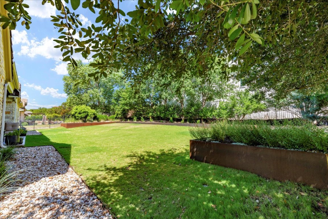 213 Black Wolf Run Austin, TX 78738 - Photo 25 of 39 a view of a field of grass and trees