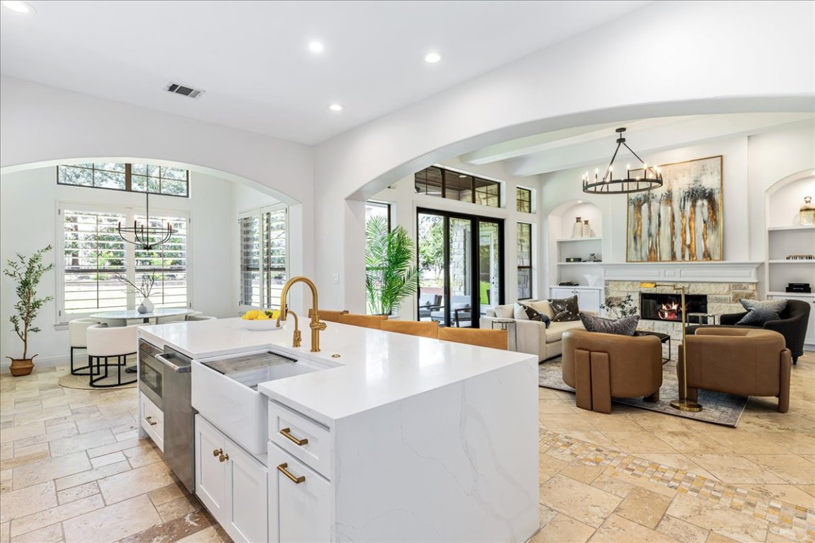 213 Black Wolf Run Austin, TX 78738 - Photo 5 of 39 a kitchen with furniture a large window and a view of living room