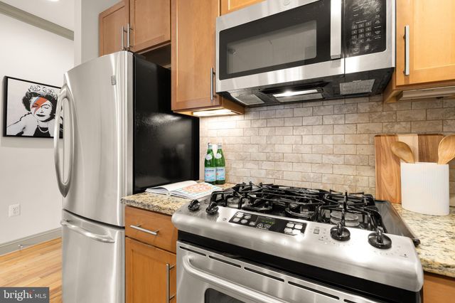 a kitchen with stainless steel appliances granite countertop a stove and a refrigerator