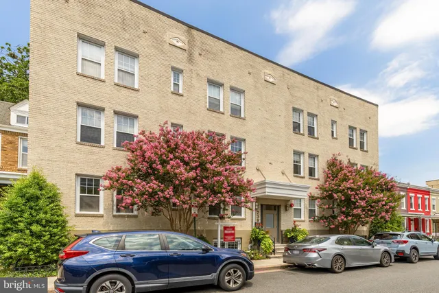 a front view of a building with parking space
