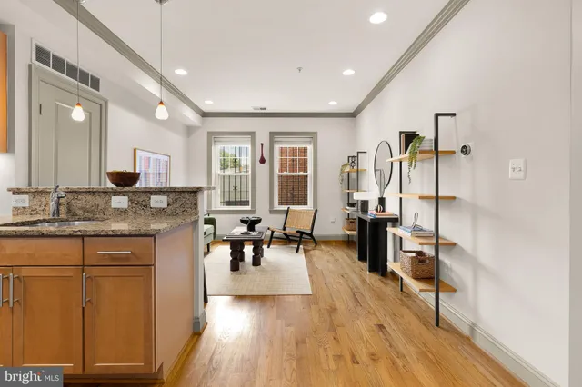 a open kitchen with sink cabinets and wooden floor