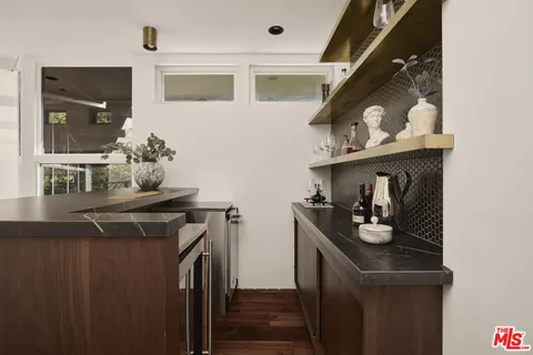 a kitchen with granite countertop a stove and a refrigerator