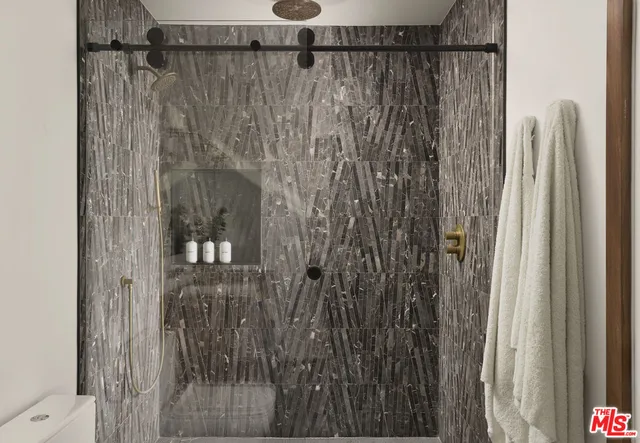 a bedroom with a large bed and a large window