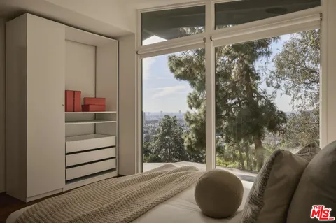 a bedroom with a bed and a mirror