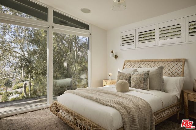 a bedroom with a bed and a mirror