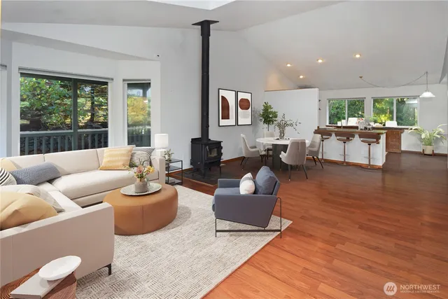 a living room with furniture a large window with wooden floor