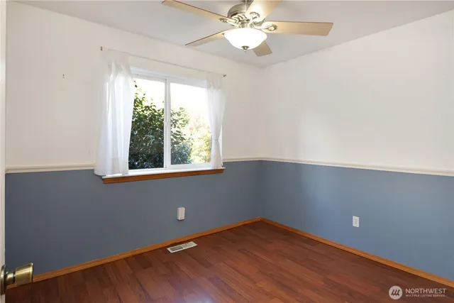 an empty room with wooden floor