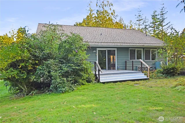 a view of a house with a yard and sitting area