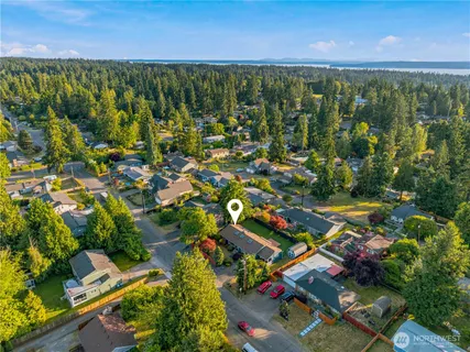 an aerial view of residential house with outdoor space and trees