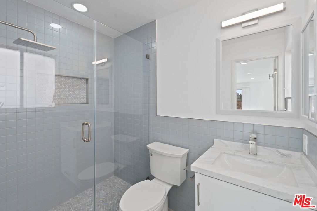 122 Buccaneer Street, Unit 3 Marina del Rey, CA 90292 - Photo 15 of 31 a bathroom with a toilet sink shower and mirror