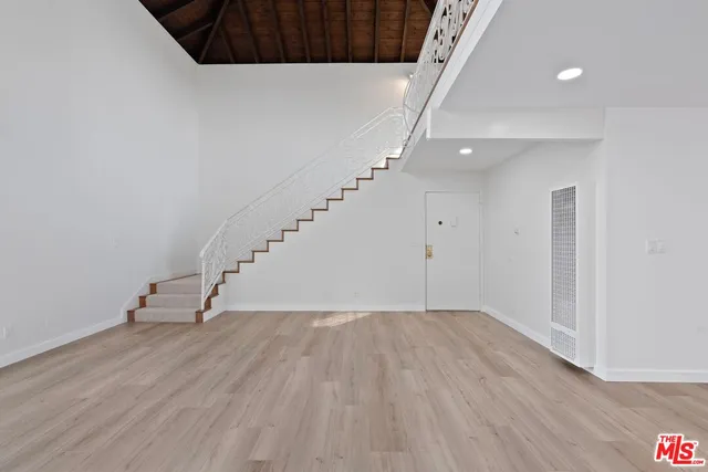a view of entryway with stairs and wooden floor