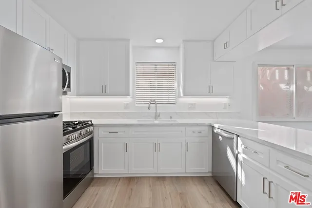 a kitchen with a sink stove and refrigerator