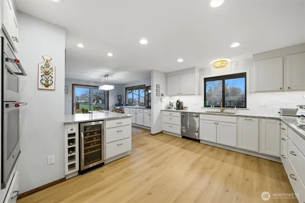 a kitchen with white cabinets and white appliances