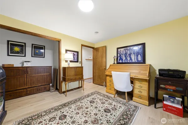 a living room with furniture and a dresser