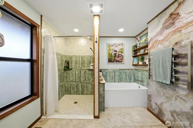 a bathroom with a tub and shower