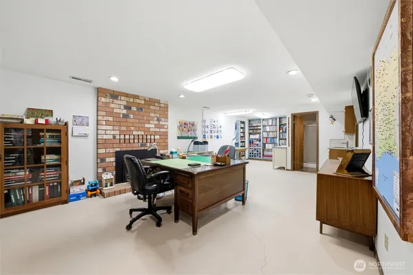 a view of a livingroom with workspace and a window